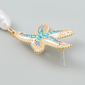 Macro shot of starfish earring with blue gradient crystals and a white baroque pearl drop