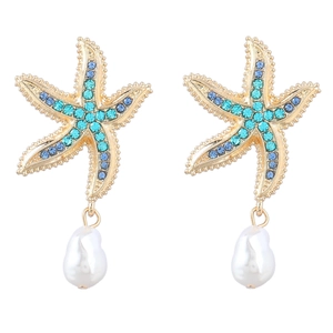 Detailed close-up of golden starfish earrings with blue rhinestones and baroque pearl drops