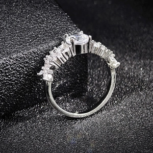 Elegant silver marquise cut zircon ring with a large round center stone on black cushion