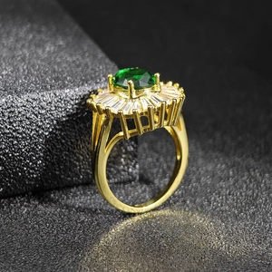 Detailed side view of vintage gold-plated ring with large emerald green zircon stone
