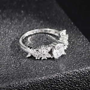 Silver marquise butterfly ring with large round zircon on black textured surface