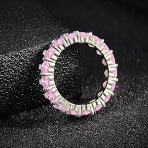 Elegant silver pink zircon eternity ring with claw-set gemstones on black background