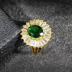 Elegant gold emerald cubic zirconia ring with sunflower halo and split shank design