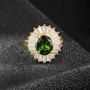 Vintage emerald-cut green zircon cocktail ring with sunburst halo and gold setting
