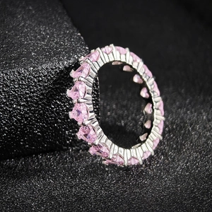 Elegant silver eternity ring featuring a full circle of pink heart-cut gemstones