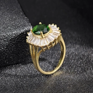 Vintage gold ring with emerald green zircon and radiant white cubic zirconia accents