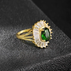 Macro side view of a vintage emerald-cut green zircon ring with gold split-shank band