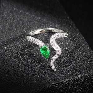 Minimalist snake-shaped open ring featuring green pear-cut gemstone and white zircons