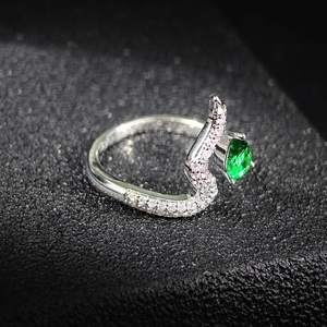 Elegant snake-head shaped open ring with pear-cut green gemstone and micro-pave crystals