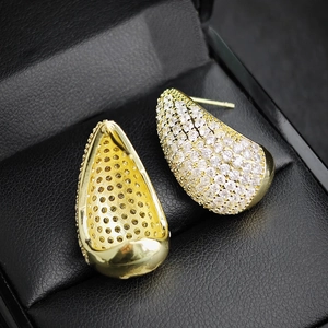 Fashionable golden teardrop earrings featuring micro-pave white zircon stones on black leather