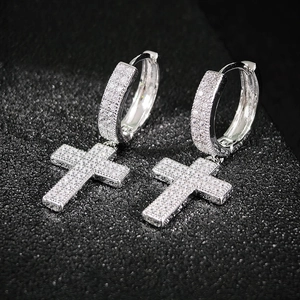 Sparkling silver cross drop earrings with cubic zirconia pavé on black jewelry stand