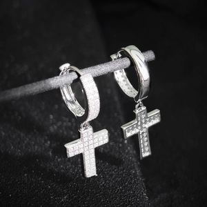 Macro shot of silver cross drop earrings with sparkling zircon pave insets