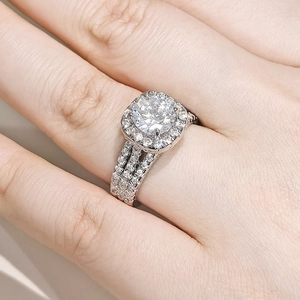 Detalle de un anillo de compromiso con halo cuadrado y una piedra de circonita redonda