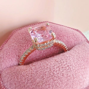 Elegant rose gold ring with large square pink zircon in a luxury velvet gift box