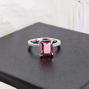 Macro shot of S925 silver ring featuring a large rectangular red gemstone in four-prong setting
