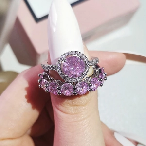 Elegant two-piece silver ring set with pink round zircon center and matching band