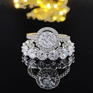 Macro shot of silver halo engagement ring set with round zircon on black reflective base