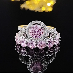 Elegant silver ring set with pink round halo gemstone and matching wedding band