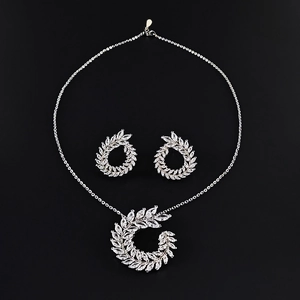 Elegant silver jewelry set with marquise-cut stones featuring a leaf design on black background