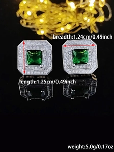 Detail view of square green gemstone earrings with double halo zirconia stones