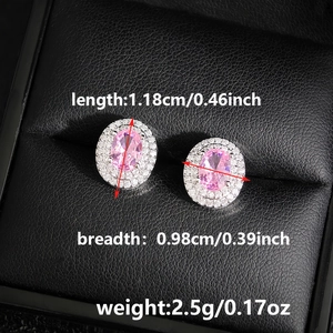 Macro detail of pink zircon stud earrings with double halo stones on black leather