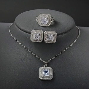Elegant 4-piece silver jewelry set with square cut stones including ring earrings necklace