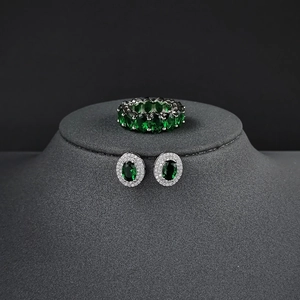 Elegant silver jewelry set with emerald green oval zircon stones and brilliant diamonds