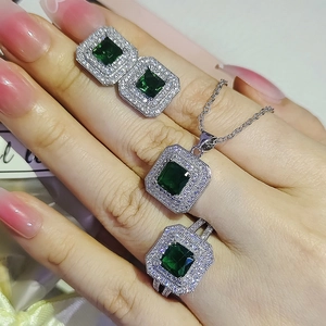 Luxurious 4-piece jewelry set with square emerald green stones and diamond accents