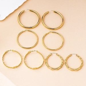 Set of four gold hoop earrings featuring thick, slim, bamboo, and Bless letter designs