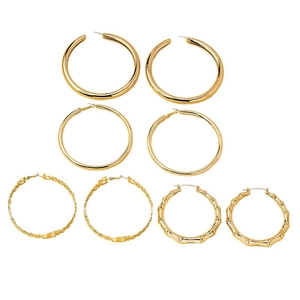 Set of four gold punk bamboo-style hoop earrings including letter B charm design
