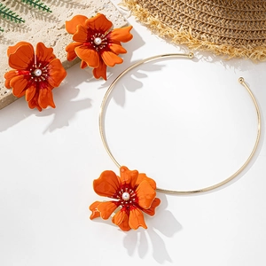 Detail of orange floral jewelry set with golden choker, earrings and white pearls