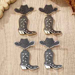 Detail of vintage cowboy hat and boot earrings in gold and silver finish set