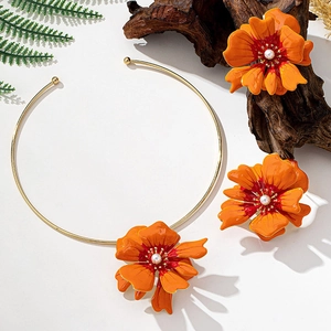 Artistic gold necklace and earrings set with orange enamel flowers and white pearls