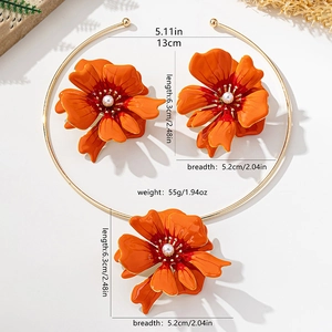Detail of large orange flower jewelry set with gold collar necklace and pearl earrings