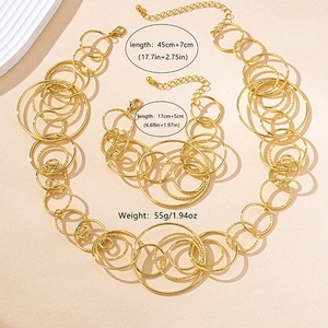 Detailed view of golden irregular geometric rings with hammered and polished metal textures