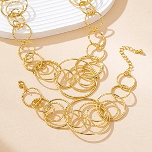 Detail of multi-layered golden irregular circle necklace with hammered texture finish