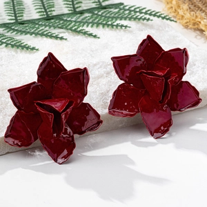 Detailed close-up of wine red 3D flower earrings with glossy enamel finish on white base