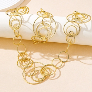 Detail of golden geometric multi-circle necklace with shiny and textured sandblasted finish