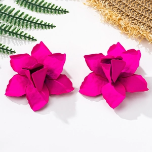 Close-up of 3D layered magenta flower stud earrings with a matte metallic finish
