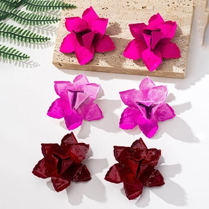 Close-up of geometric floral earrings in matte rose, bright pink and glossy burgundy finish