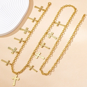 Elegant gold cross pendant body chain set with hammered texture on a minimalist background