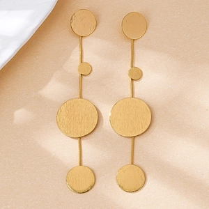Detailed view of large gold layered geometric drop earrings with a brushed metal texture finish