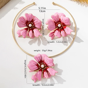 Detail of pink enamel flower jewelry set with golden frames and white pearl centers