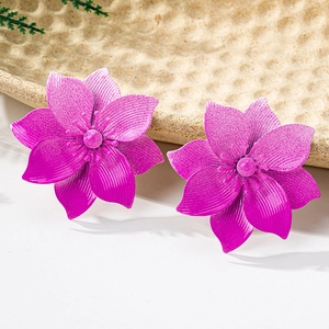 Detailed close-up of dark pink 3D flower earrings with textured petals and center pearl