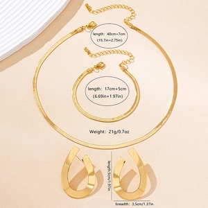 Detailed view of gold jewelry set showing flat snake chain necklace and teardrop earrings