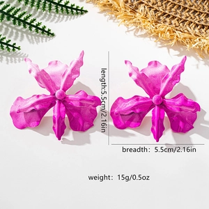 Detailed view of oversized magenta flower earrings with 5.5cm dimensions and matte finish