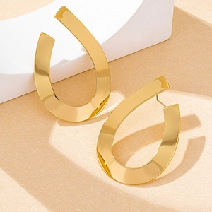 Detailed view of polished gold teardrop earrings with a modern minimalist metal design
