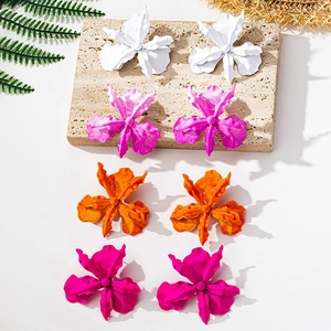 Detail of colorful matte floral earrings in white, pink, orange and magenta colors