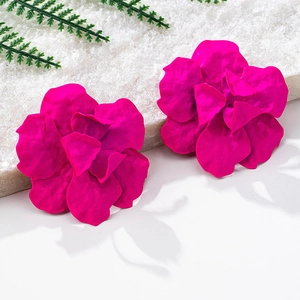 Close-up of elegant magenta floral stud earrings with matte finish and layered petals