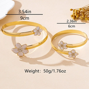 Vue détaillée des bracelets de bras spirale dorés avec motifs fleurs de cerisier
